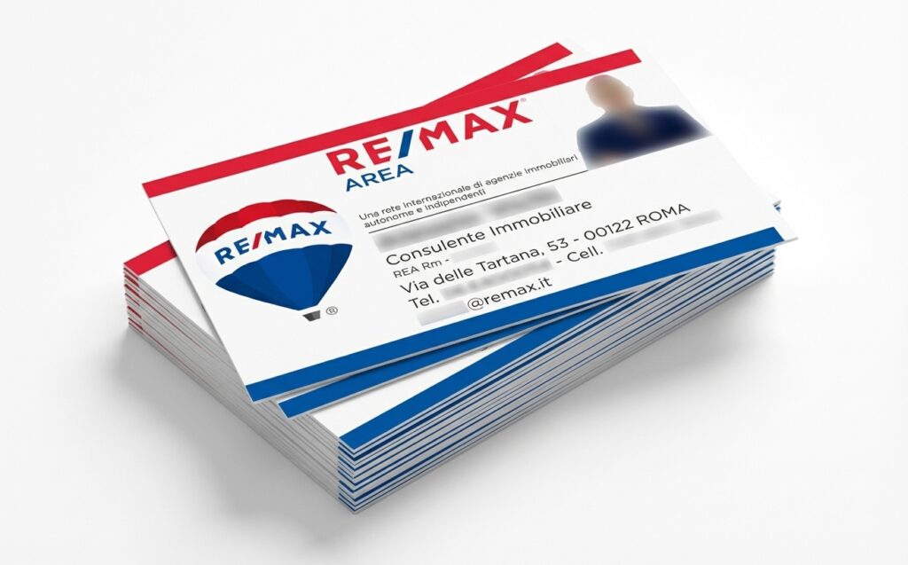 RE/MAX real estate business cards with professional red, white, and blue branding design.